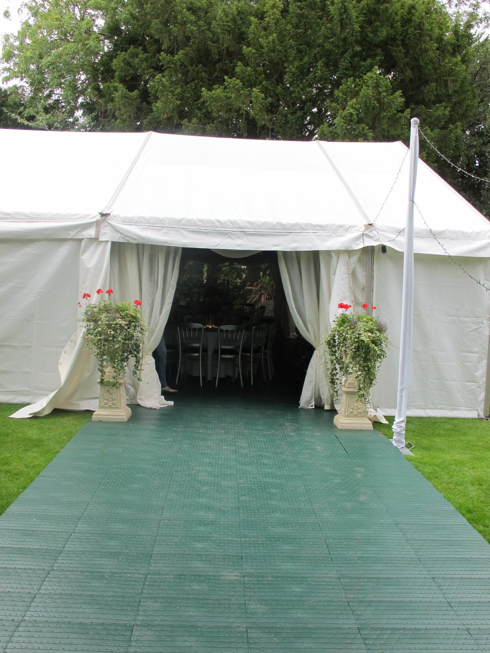 Temporary outdoor flooring panels protecting grass during an event setup